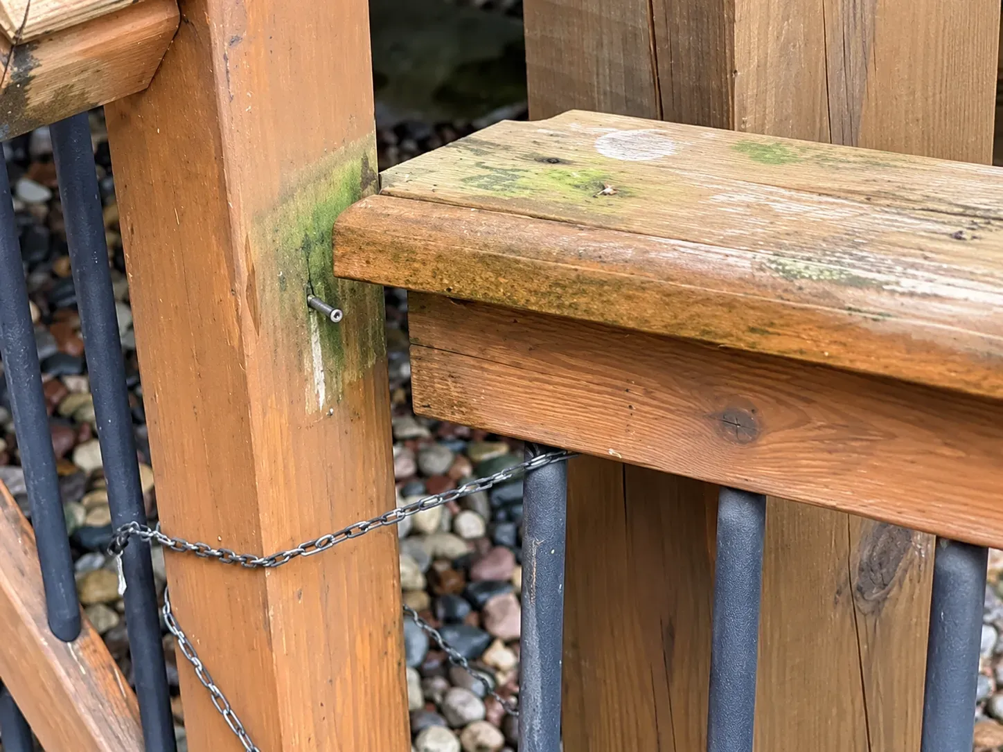 Close-up of weathered cedar railing and post on the original Eagan deck