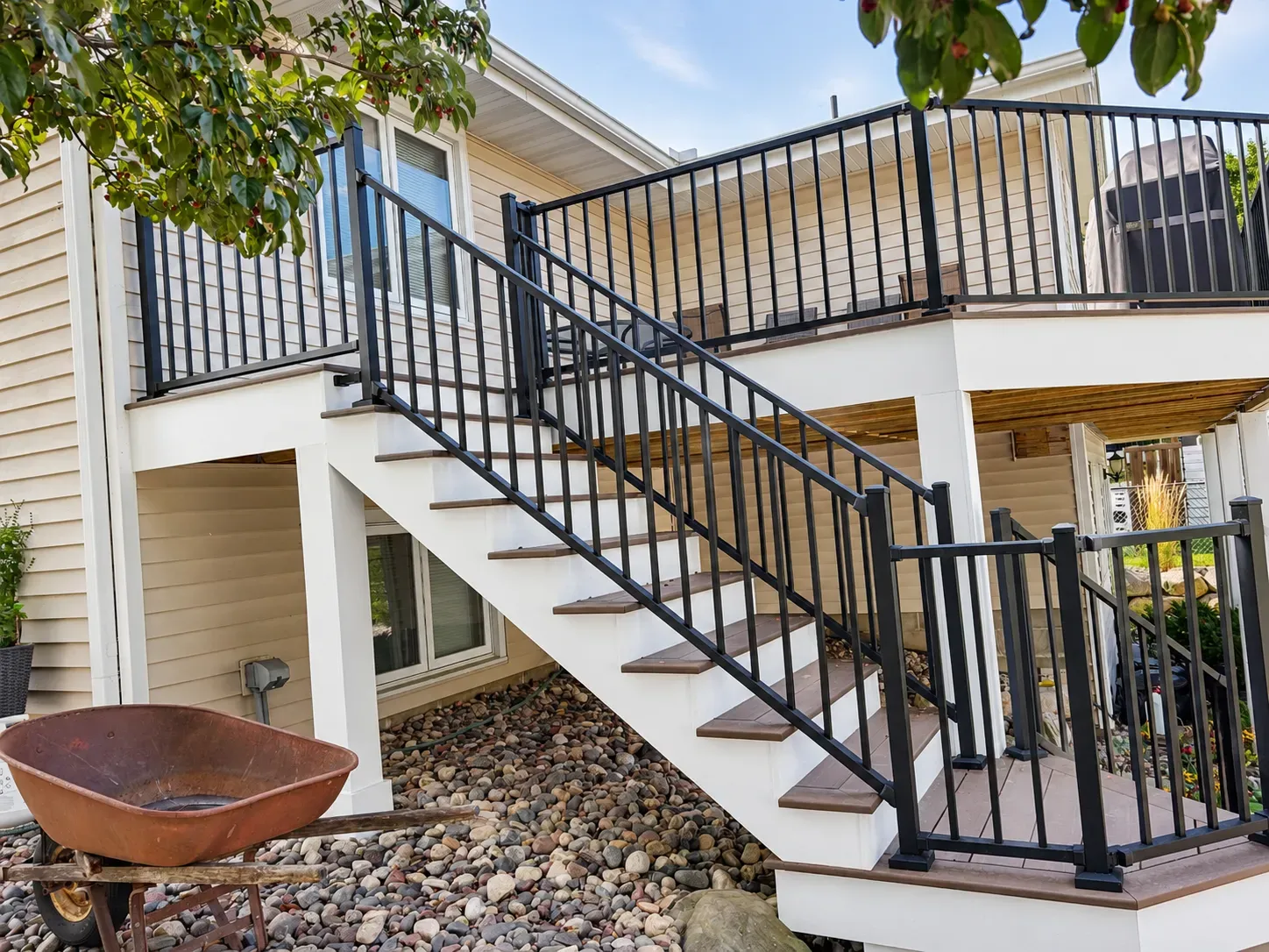 Rebuilt deck stairway with aluminum railing leading down from the Eagan deck