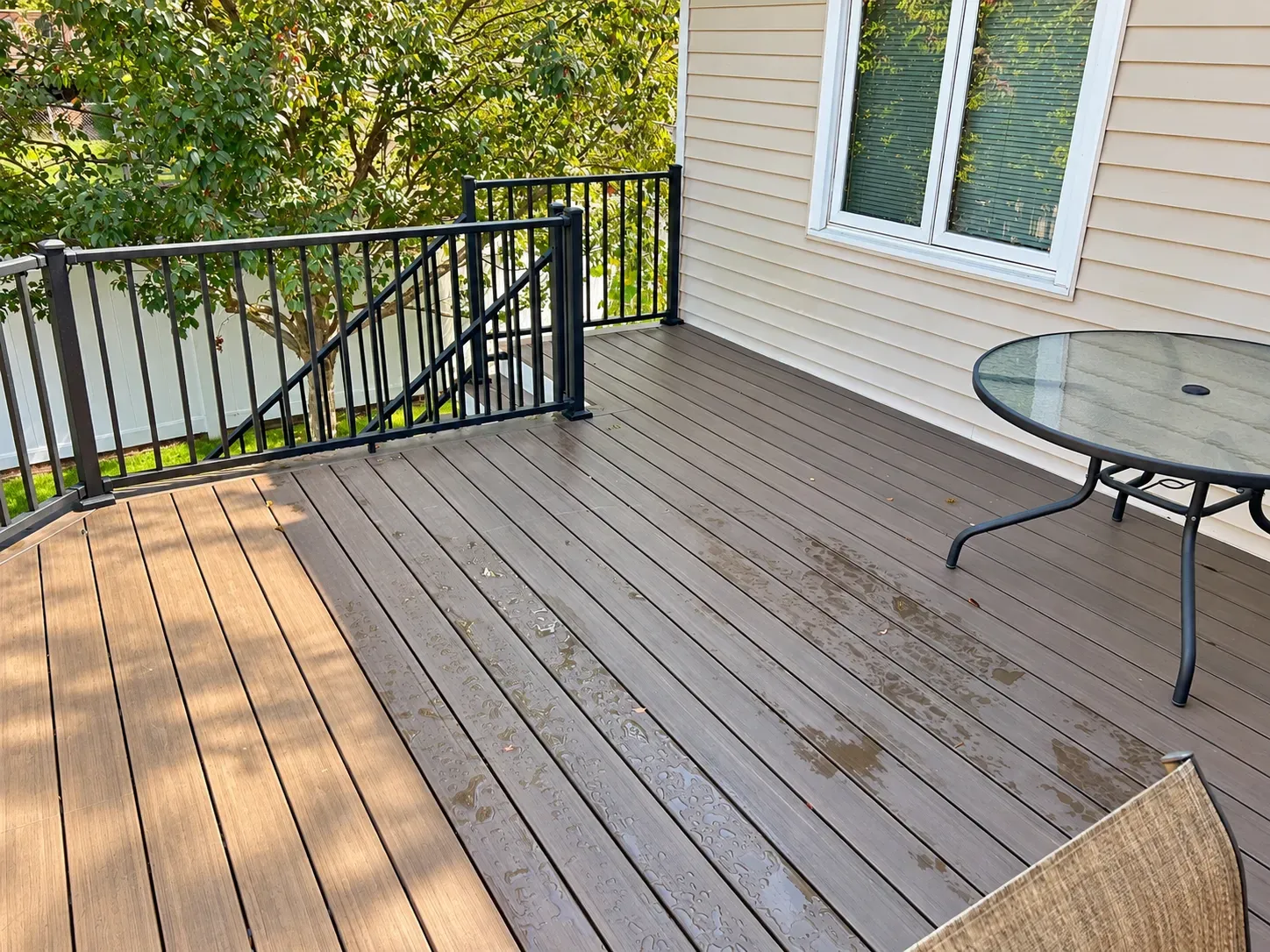 Composite decking surface with hidden fasteners and black aluminum railing on the Eagan deck