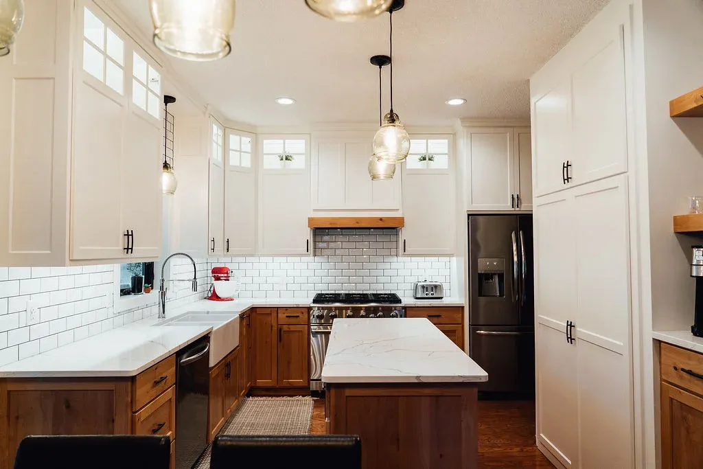 Remodeled Lakeville kitchen with stained alder base cabinets, painted poplar uppers, and layered lighting
