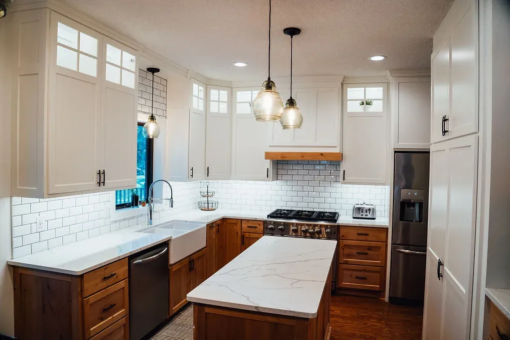 Finished Lakeville kitchen remodel with stained alder cabinetry, quartz countertops, and layered lighting by Honey-Doers Remodeling