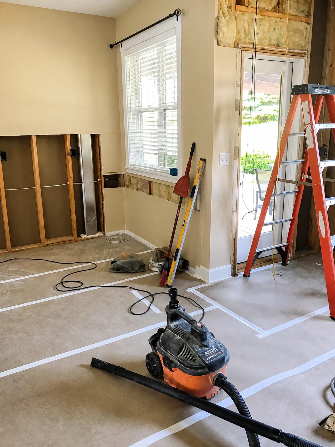 Protective floor covering and taped seams during demolition in the Lakeville main-level remodel