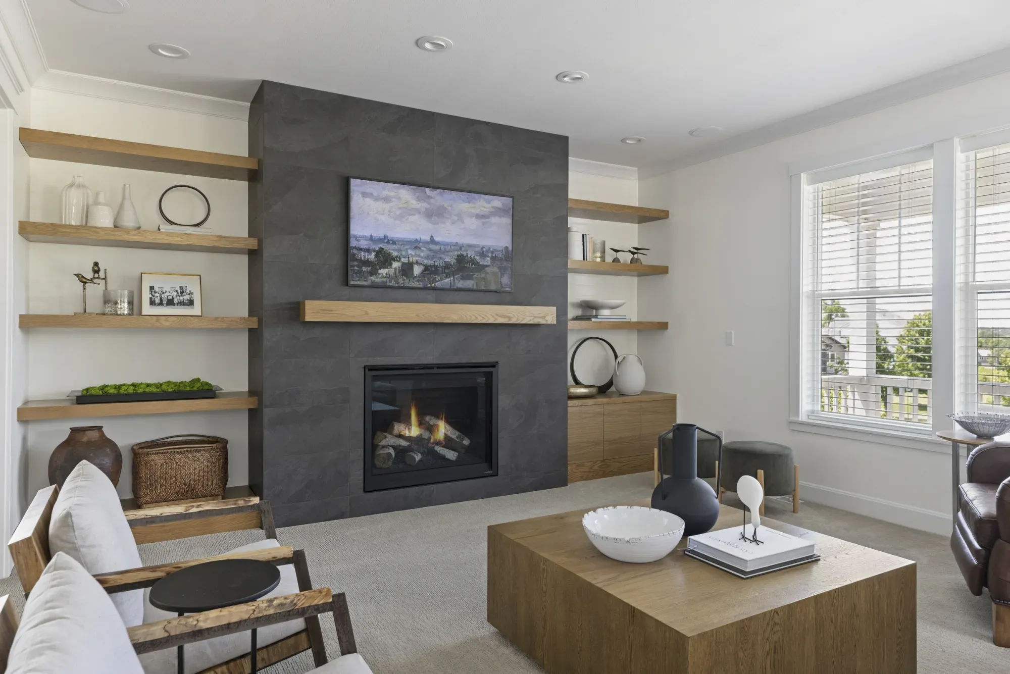 Quarter-sawn white oak cabinetry and floating shelves framing a gas fireplace in a Lakeville, MN living room remodel