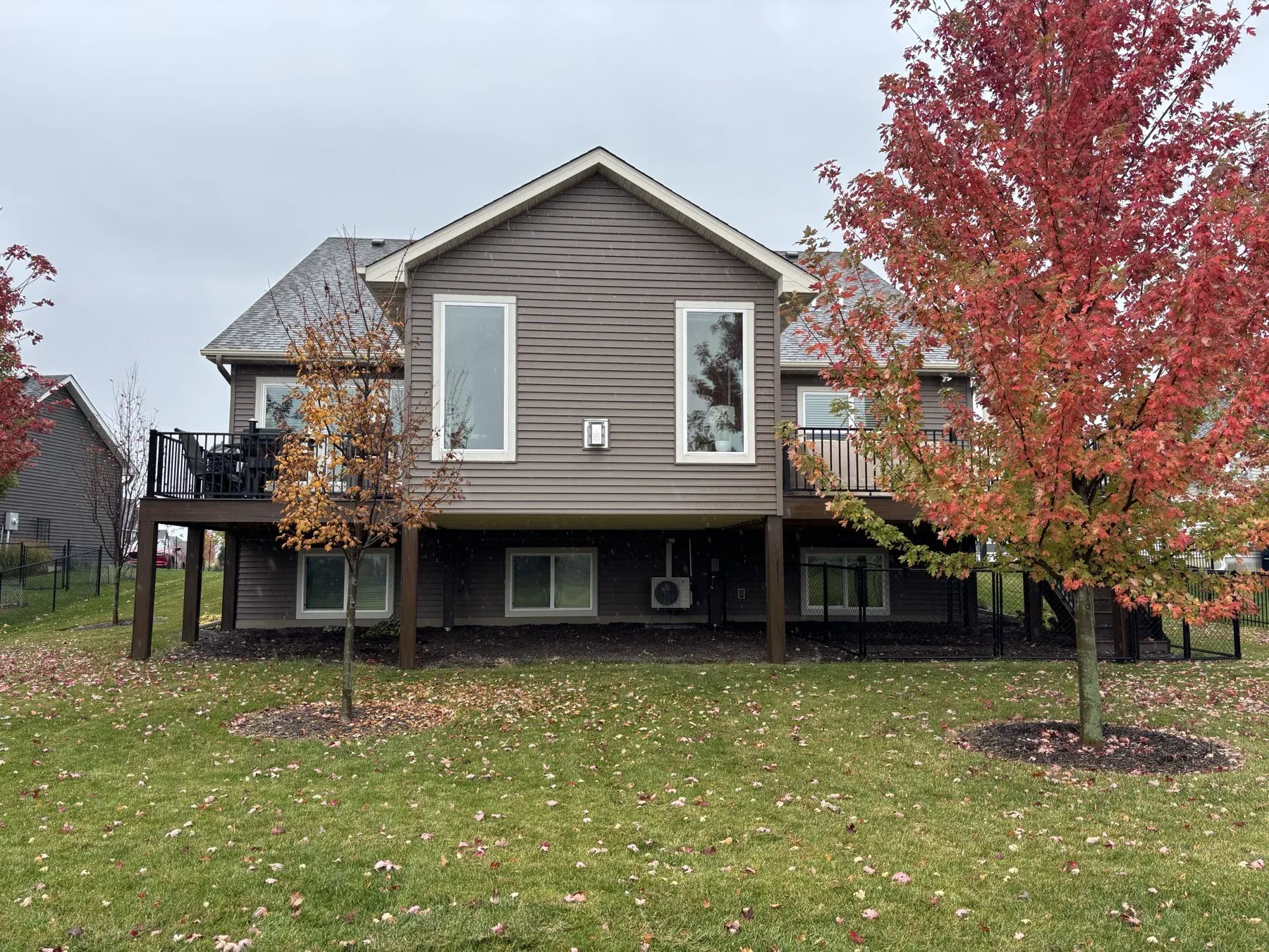 Back of the Lakeville home showing the four-season porch with a composite deck on each side