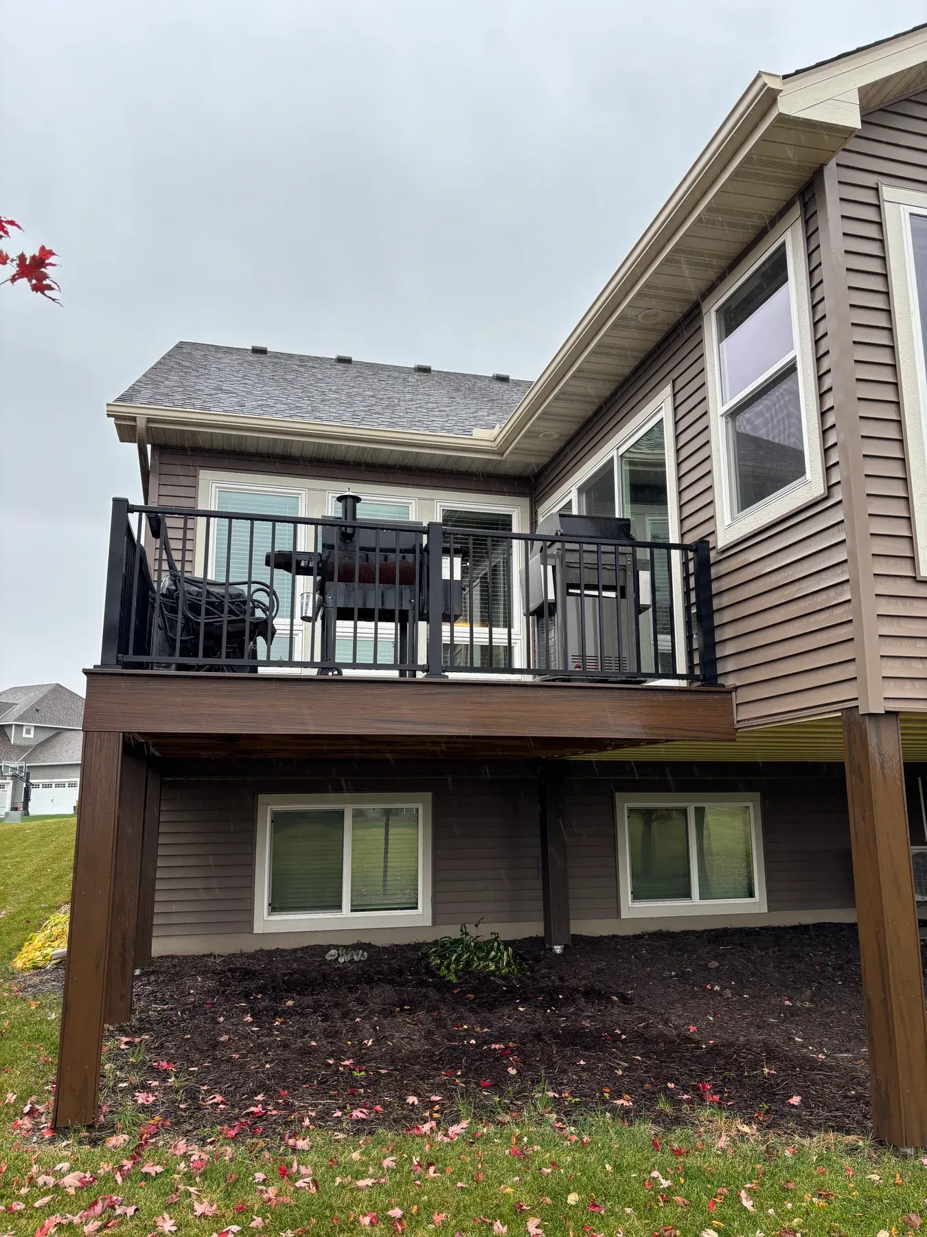 Composite grilling deck with Westbury aluminum railing beside the Lakeville porch