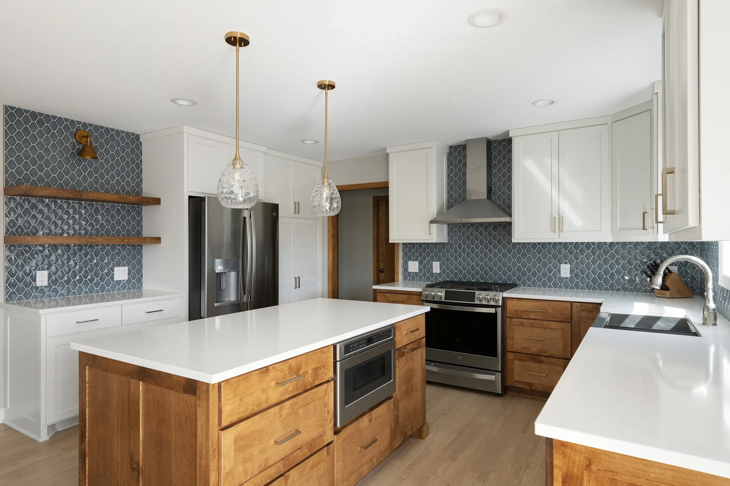 New kitchen island replacing peninsula in Elko New Market kitchen remodel – warm wood base cabinets and quartz countertop by Honey-Doers Remodeling
