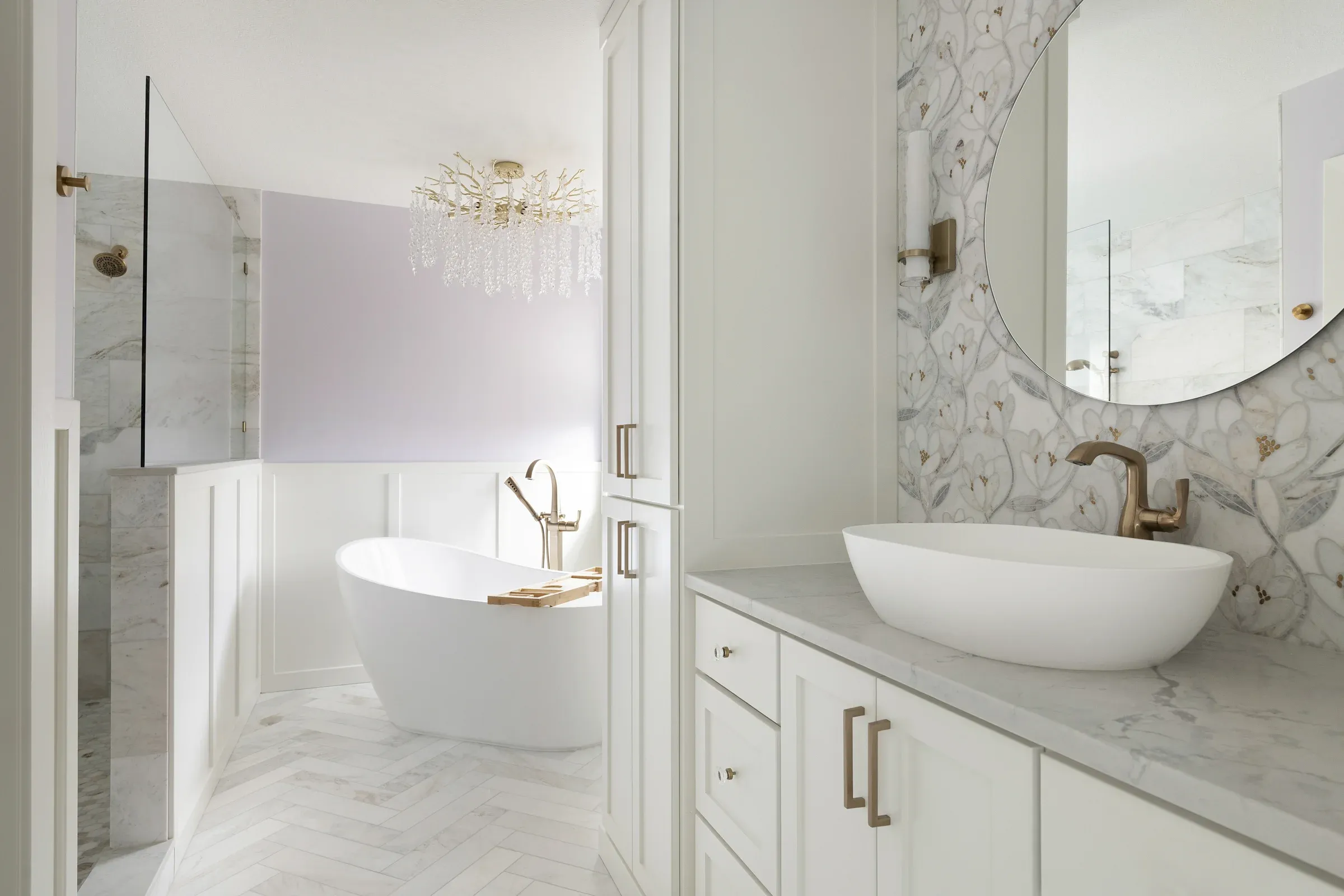 Primary bathroom remodel in Elko New Market MN – freestanding soaking tub, walk-in marble shower, vessel sink vanity, and crystal chandelier by Honey-Doers Remodeling